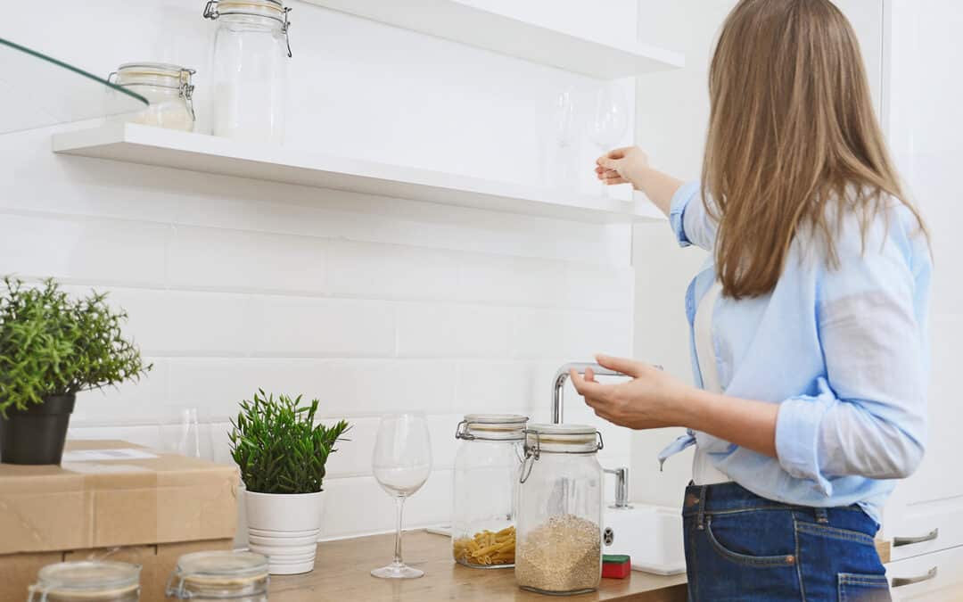 A woman organizing her apartment at The Domain at Bennett Farms.