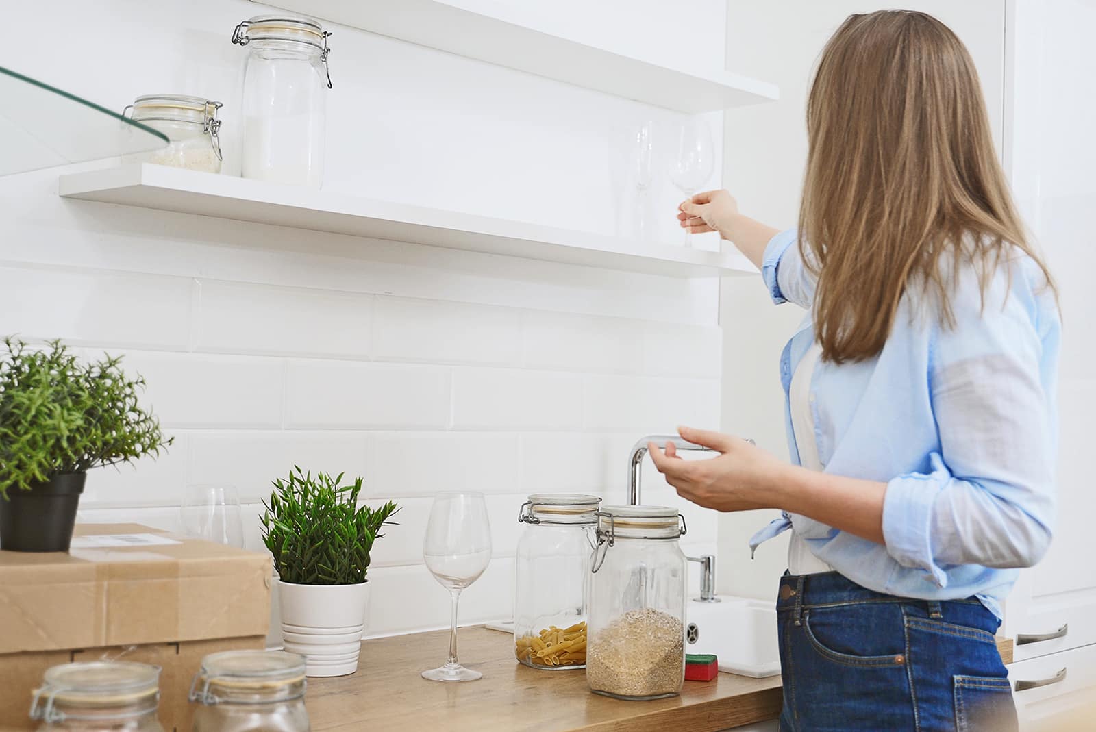 A woman organizing her apartment at The Domain at Bennett Farms.